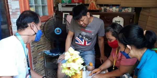 Home visit in Barangay, Philippines, by Persons with Disability Assistance Desk Coordinators.