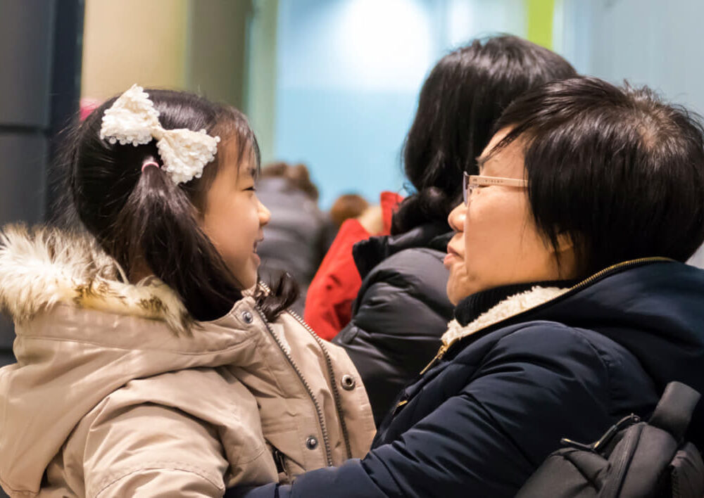 South Korean grandmother holding granddaughter.
